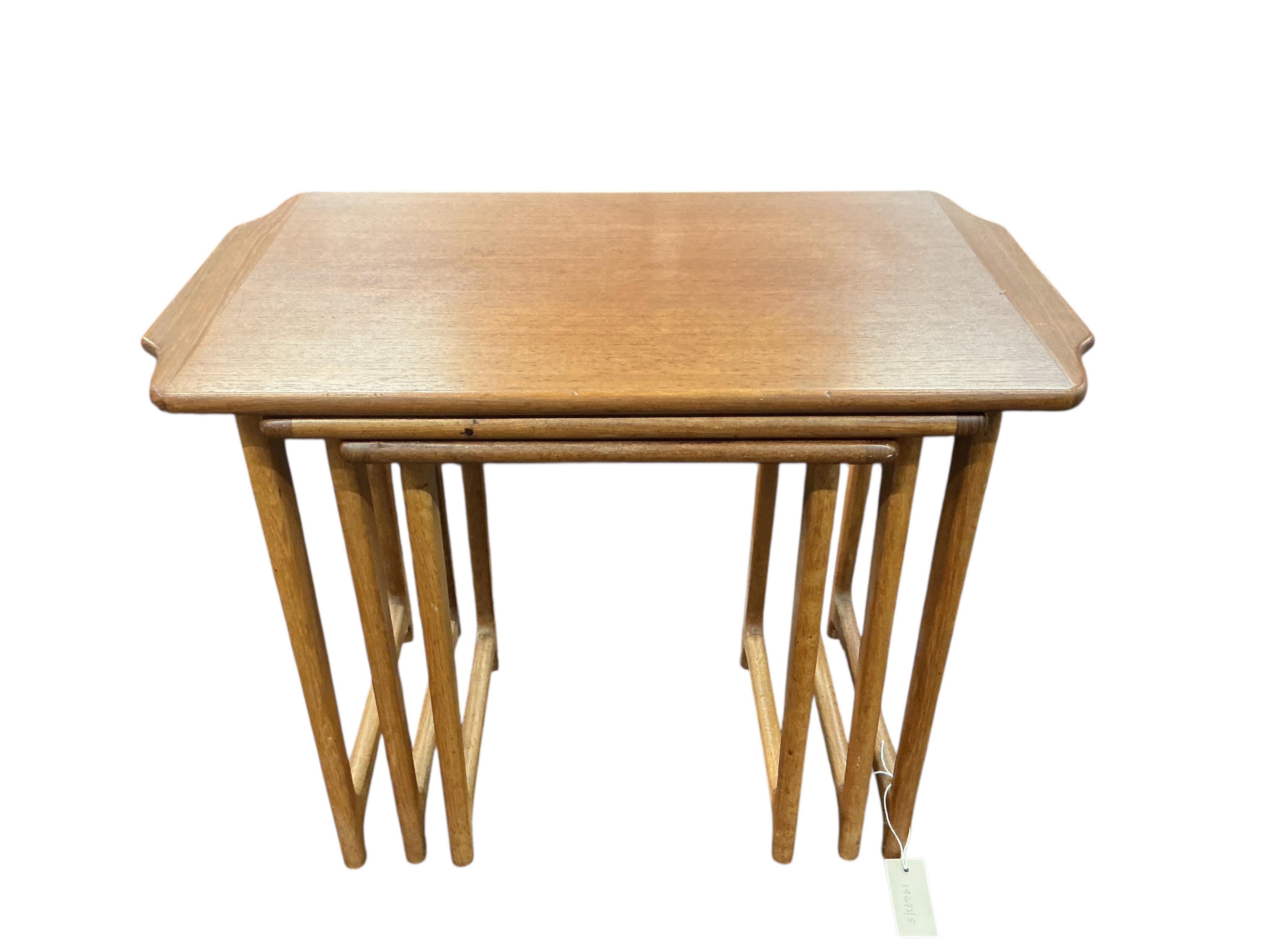 A nest of three mid century teak rectangular tables, width 65cm, depth 38cm, height 51cm